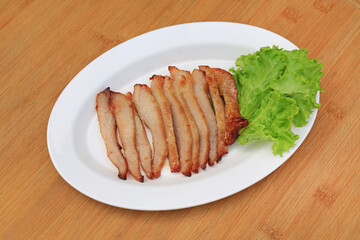 Grilled pork, Roasted pork neck in white plate on wood background.