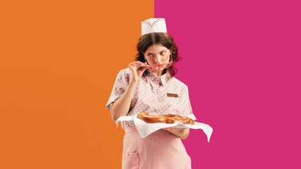 Portrait of young female waitress, sensual woman in retro american fashion style of 70s, 80s in action motion over vivid colors background. Food pop art