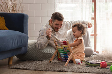 Happy loving young multiracial family African American mother Caucasian father playing with little cute mix race ethnic baby toddler girl at home. Quality time family with an educational didactic toy. - obrazy, fototapety, plakaty