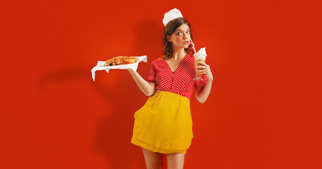 Beautiful young girl in image of retro cater waiter wearing 70s, 80s fashion style uniform isolated over red studio background. Trash pop art, retro vivid palette