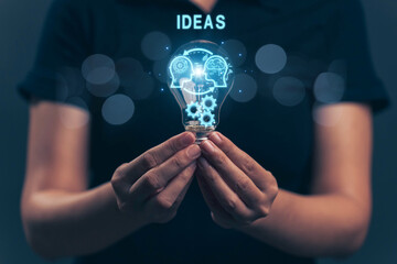 Glowing light bulb in hand, idea search concept Creativity from information trade in the internet world, marketing, business ideas and target groups.