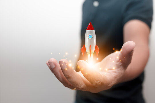 Businessman launches a rising rocket Successful startup concept, leadership leads to success or business vision.