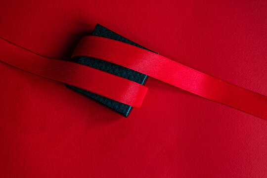 Black gift box with red ribbon