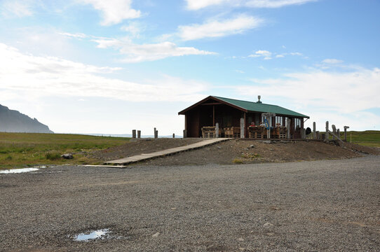 View of a house in a field on a beautiful day in Iceland
