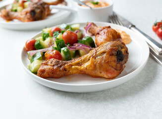 Low carb dinner with oven baked chicken, marinated salad and paprika feta cheese dip on a plate