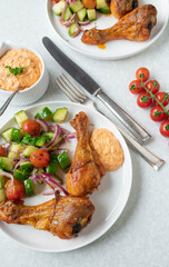 Summer dinner or lunch with baked chicken drumsticks and feta cheese, paprika dip. Served with a...