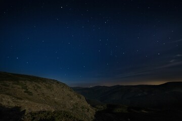 Fototapeta na wymiar Beautiful night over a highland with mountain range
