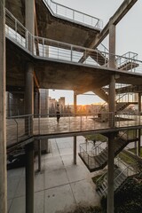 Vertical shot of an outdoor metal urban staircase with sunset in the background