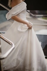 Shallow focus of a bride in a white wedding dress outdoors