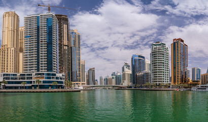 Fototapeta na wymiar Tall apartment blocks surround the water at Dubai Marina in the UAE