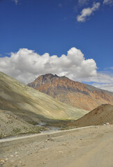 View of a beautiful rocky mountain with clouds in sky and flowing a river on the way of Darcha-Padum road, Ladakh, INDIA. 