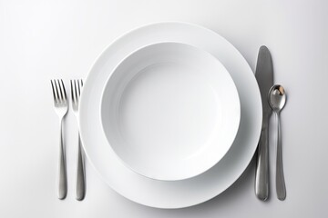  a white plate with silverware on a white tablecloth with a silver fork and knife next to the plate with a silver spoon and knife.  generative ai