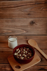 Corn balls for breakfast with milk on a wooden background