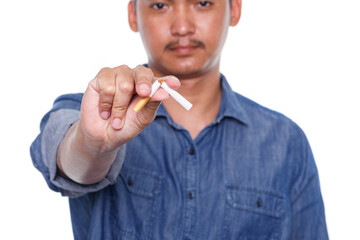 Man holding broken cigarette in hands isolated on white background. Stop smoking cigarettes...