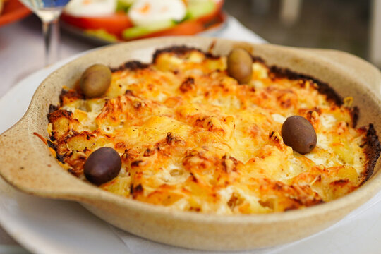 Bacalhau com Natas, most famous Portuguese dishes made with salted cod served in a mixture of cream, potatoes, and onion