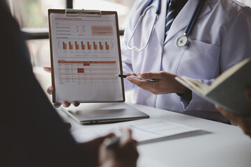 Meeting room in a hospital with a group of doctors attending an informational presentation, a...