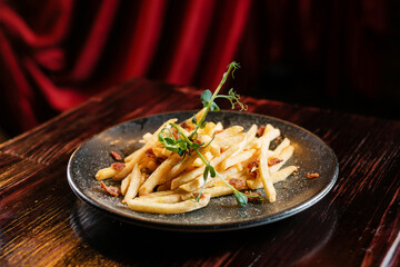 french fries with spices on wooden table
