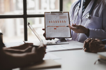 Meeting room in a hospital with a group of doctors attending an informational presentation, a...