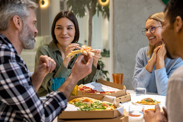 Friends having good time during lunch and enjoying pizza