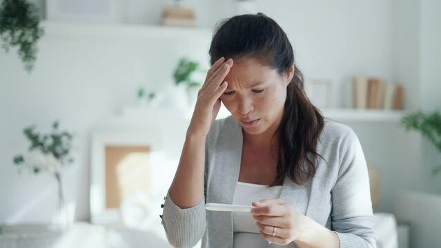 Video of worried stressful woman looking at predictor finding out she is pregnant at home