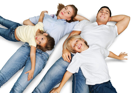Portrait of happy family lying on floor with two kids