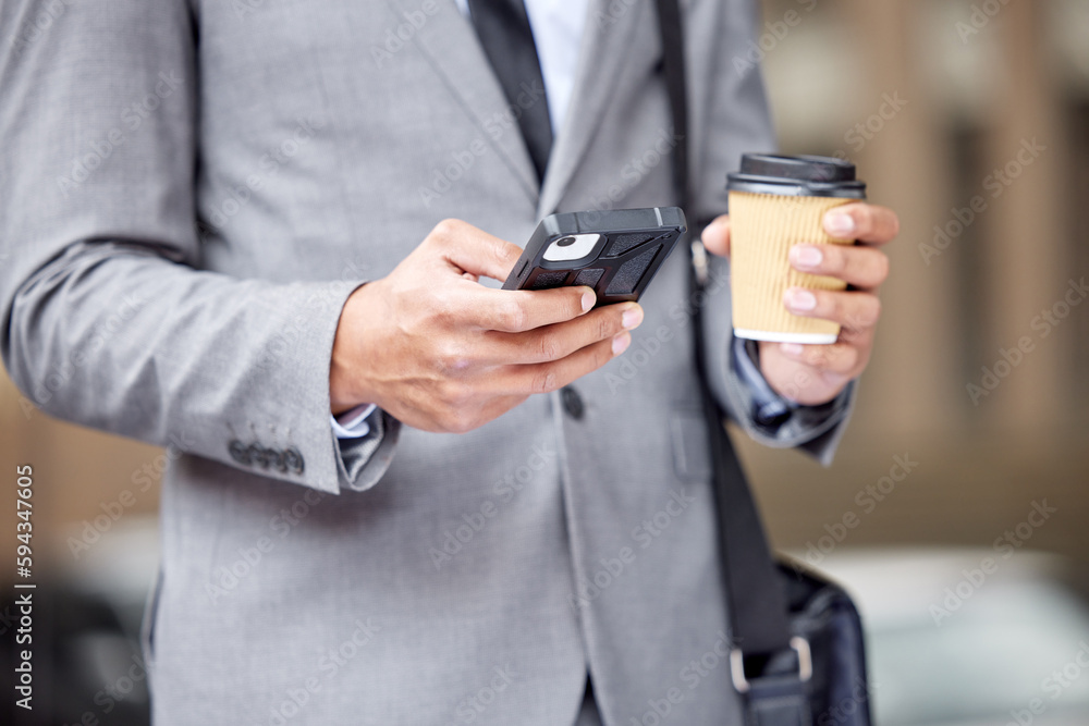 Poster caffeinated and ready to start the day. an unrecognizable businessman standing and using his cellpho