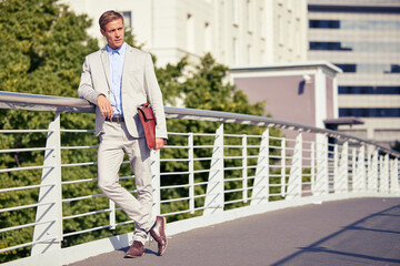 Bridging the gap between ambition and success. Full length shot of a handsome young businessman...