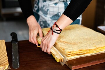 Closeup view of a woman making a cake.