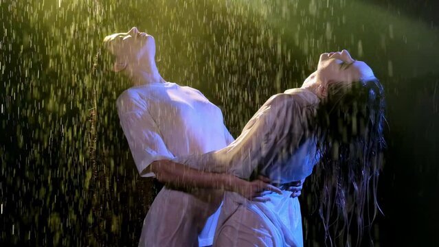 Young women in wet shirts bend and hold each other. Tender ladies stand under pouring rain and enjoy bad weather in nighttime Generative AI