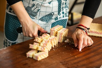 Closeup view of a woman making a cake.