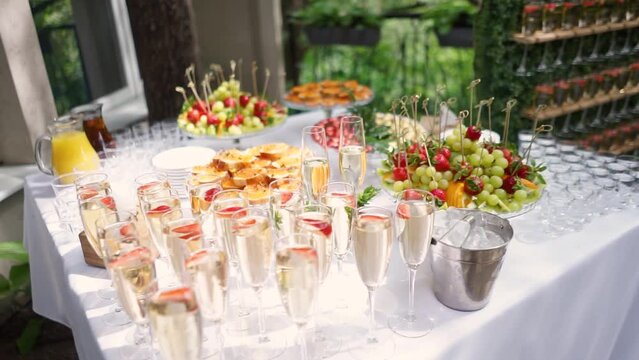 Champagne in glass glasses stands on a wedding buffet on the table during the wedding ceremony