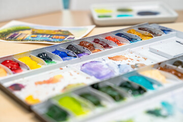 Colorful of watercolor tray background with watercolor set. Selective focus.
