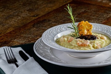 White ceramic bowl filled with soup on a wooden table
