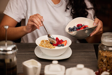 Never skip the most important meal of the day. an unrecognizable woman having breakfast at home.
