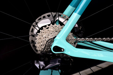 isolated bicycle rear wheel closeup view. gearshift, gearwheel and black spokes. mechanical design...