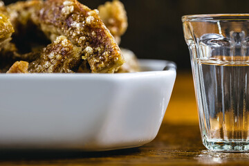 Cachaça, drops, cane or sugar cane is the name given to brandy produced in Brazil. Served with pork crackling. Typical food and drinks from Brazilian restaurants or bars.