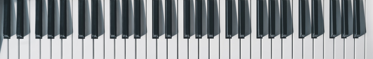 Naklejka premium Photo of piano keys in the morning together with light and shadow. Musical instrument keyboard. 