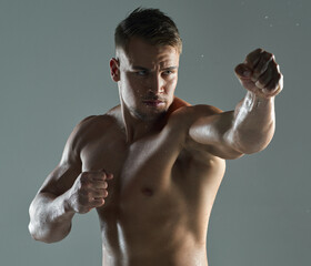 Be determined in everything you do. a young man practicing his punches against a studio background.