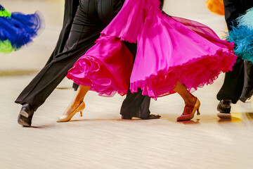 close-up part pink ball gown and and man black tail suit on dance floor