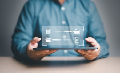 Data Sync concept, Transfer file of data between folder, Backup data, Exchange of file on folder, Send document in internet, DMS. Virtual document loading to another folder and hand holding tablet.