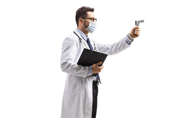 Male doctor with a face mask holding a infrared thermometer