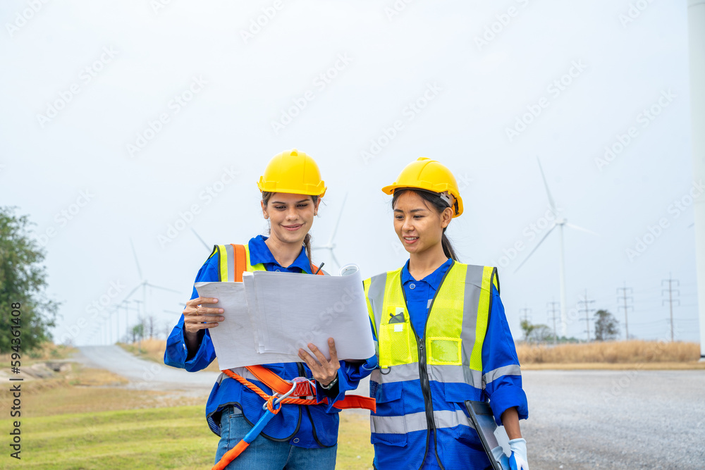 Poster Engineer man looking and checking wind turbines at field,Wind turbine farm generator by alternative green energy.
