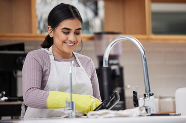 Dishes are relaxing to do sometimes. a young woman doing the dishes at home.