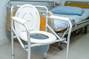 Flush toilet and shower chair in bathroom for old elder people.