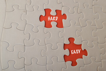 Fototapeta premium Missing jigsaw puzzle with text HARD and EASY.