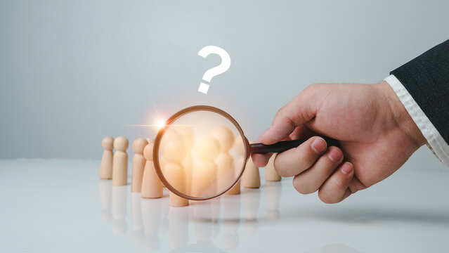 HR or human resources using a magnifying glass to look for personnel to join the organization intelligence, good problem-solving abilities, leadership qualities make towards business success.