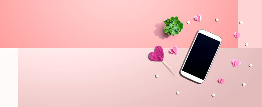 Smartphone with hearts and a succulent - flat lay