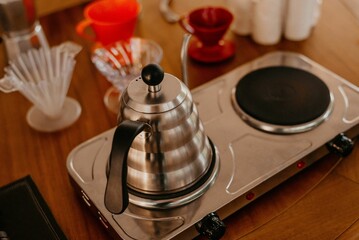Closeup of a moka pot coffee maker on a wooden table during the ceremony