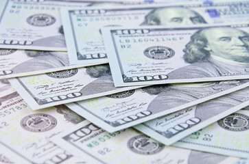 Fototapeta premium A heap of one hundred US dollar bills as business background 