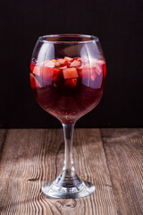 Refreshing glass of sangria over dark sound